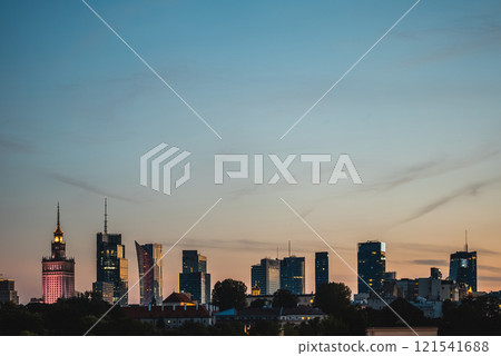 sunset over skyline of big modern city with skyscrapers and downtown district, tourist travel destination, Warsaw, capital of Poland sunset over skyline of big modern city with skyscrapers and downtown district, tourist travel destination, Warsaw, capital of Poland 121541688