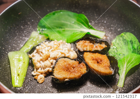 Pan-fried Enoki mushrooms wrapped in nori seaweed and bok choy Pan-fried Enoki mushrooms wrapped in nori seaweed and bok choy 121542317