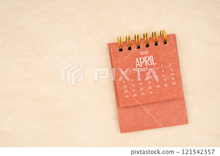 April 2025 red mini calendar on old brown paper. 121542357