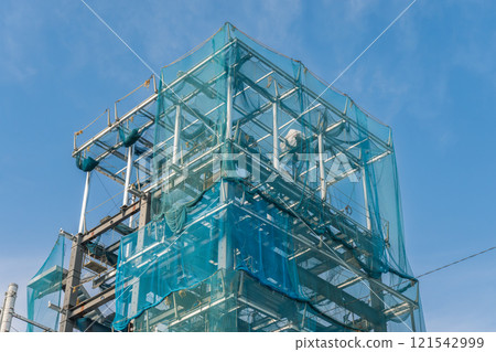 A construction site covered with protective netting 121542999
