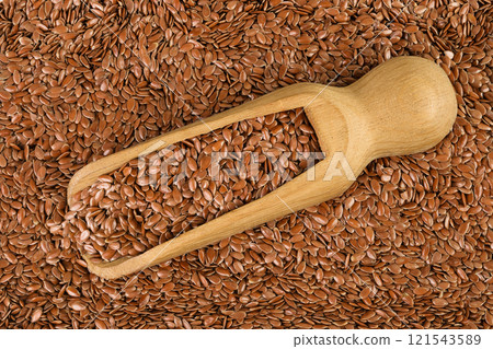 flaxseed in wooden scoop as a background. Top view. Flat lay flaxseed in wooden scoop as a background. Top view. Flat lay 121543589