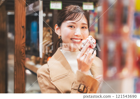 一位年輕女子懷舊地在老式糖果店購物[照片合作：大米/粗點心店加賀田Beikokuten] 121543690