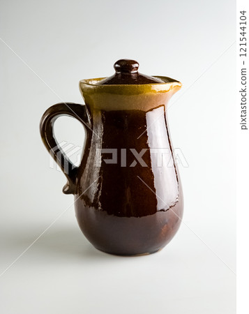 Ceramic dishes on a white background, Clay Jug. Vertical photo 121544104