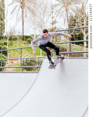 Young Skateboarder Performing Trick at Skatepark. Young Skateboarder Performing Trick at Skatepark. 121544477