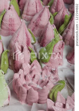 Roses, tulips and chrysanthemums from marshmallows. Zephyr flowers. Sprinkled with powdered sugar. Roses, tulips and chrysanthemums from marshmallows. Zephyr flowers. Sprinkled with powdered sugar. 121544602