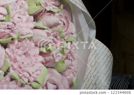 A bouquet of marshmallows. Zephyr flowers. Packed in craft paper. Close-up. A bouquet of marshmallows. Zephyr flowers. Packed in craft paper. Close-up. 121544608