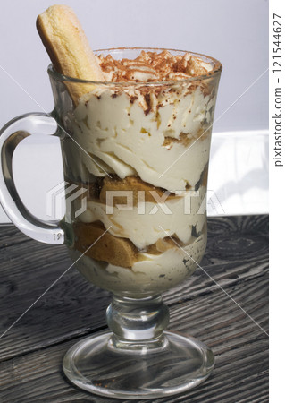 Dessert with Savoiardi cookies and cream. Tiramisu cookies. Close-up. 121544627