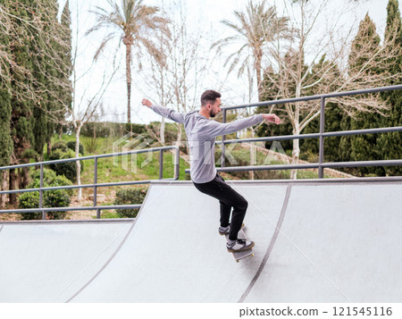 Young Skateboarder Performing Trick at Skatepark. 121545116