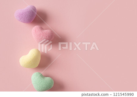 Valentine's Day four heart shaped bath salt on pastel pink background. View from above. Space for your greetings. Love and wellness concept. Valentine's Day four heart shaped bath salt on pastel pink background. View from above. Space for your greetings. Love and wellness concept. 121545990