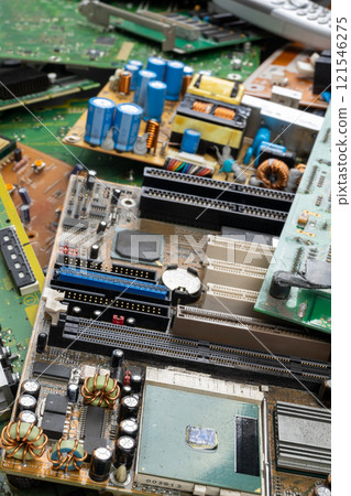 Discarded Circuit Boards Highlighting Electronic Waste and Overproduction 121546275