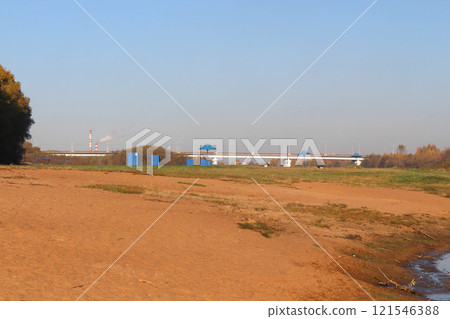 Embankment by the Berezina River, bridge across the river, yellow sand 121546388