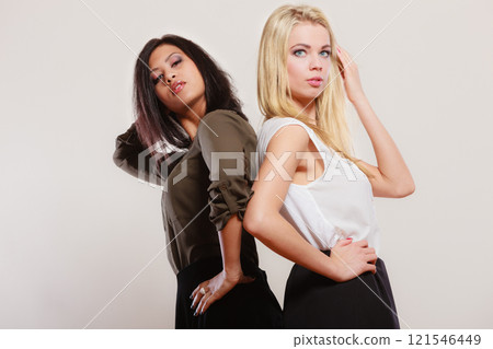 two fashion women african and caucasian posing two fashion women african and caucasian posing 121546449
