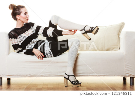 Girl fashionable dress high heels posing on couch. Girl fashionable dress high heels posing on couch. 121546511