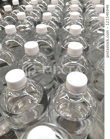 Water bottles arranged neatly on store shelves for customers to purchase 121546946