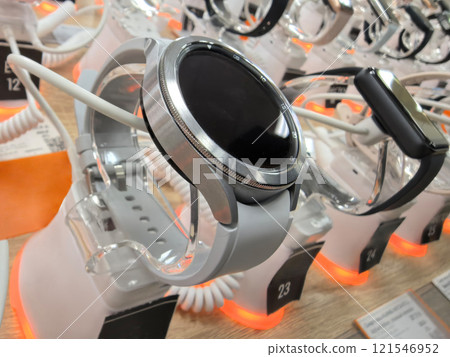 Explore the latest technology in wearable devices at the bustling store display Explore the latest technology in wearable devices at the bustling store display 121546952