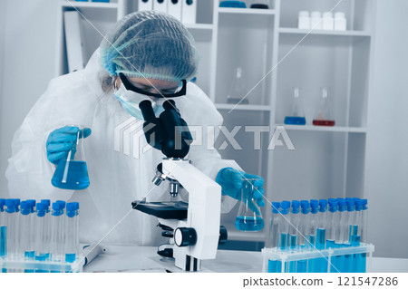A dedicated scientist diligently engaged in extensive research utilizing advanced laboratory equipment and sophisticated microscopy techniques to conduct critical experiments and analyze data 121547286