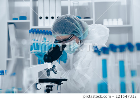 A dedicated Research Scientist is analyzing samples in a hightech lab, using advanced techniques and sophisticated equipment for extensive research across multiple scientific fields 121547312