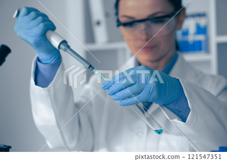 In a stateoftheart laboratory, a dedicated scientist is employing a pipette to achieve precise measurements, ensuring accuracy in all aspects of their detailed research and scientific study work In a stateoftheart laboratory, a dedicated scientist is employing a pipette to achieve precise measurements, ensuring accuracy in all aspects of their detailed research and scientific study work 121547351