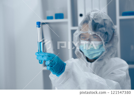 A dedicated scientist analyzes a test tube in a hightech lab, showcasing the complexities of scientific inquiry and the importance of thorough research in biochemistry and microbiology 121547380