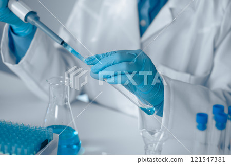 A Laboratory Technician is currently engaged in conducting a detailed experiment using a pipette within a modern laboratory environment, illustrating key themes in scientific research and safety A Laboratory Technician is currently engaged in conducting a detailed experiment using a pipette within a modern laboratory environment, illustrating key themes in scientific research and safety 121547381