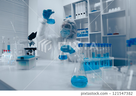 A dedicated scientist is actively conducting a detailed experiment in a stateoftheart modern laboratory, utilizing advanced techniques and an array of tools to explore new scientific ideas A dedicated scientist is actively conducting a detailed experiment in a stateoftheart modern laboratory, utilizing advanced techniques and an array of tools to explore new scientific ideas 121547382