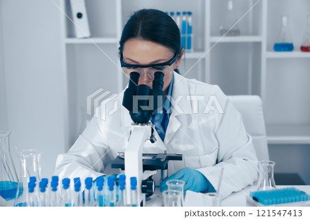 A scientist is diligently analyzing various samples under a highpowered microscope in a laboratory setting, showcasing the intricate work involved in modern scientific research and experimentation A scientist is diligently analyzing various samples under a highpowered microscope in a laboratory setting, showcasing the intricate work involved in modern scientific research and experimentation 121547413
