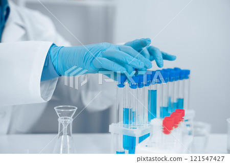 A dedicated scientist conducting a detailed and meticulous experiment utilizing an assortment of test tubes within a fully equipped laboratory, focusing on precision and innovative research methods A dedicated scientist conducting a detailed and meticulous experiment utilizing an assortment of test tubes within a fully equipped laboratory, focusing on precision and innovative research methods 121547427