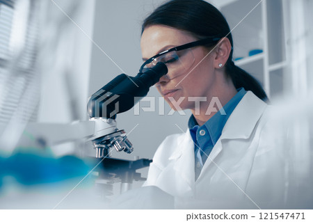 In a modern lab, a dedicated scientist observes biological specimens through a highpowered microscope, showcasing the precision and innovation vital for advancing science and research In a modern lab, a dedicated scientist observes biological specimens through a highpowered microscope, showcasing the precision and innovation vital for advancing science and research 121547471