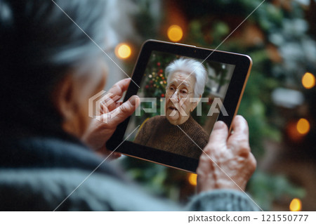 Elderly woman video chatting with family using a tablet during festive season. Generative AI 121550777