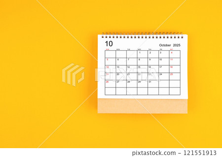 October 2025 desk calendar on yellow color background, position with copy space. 121551913