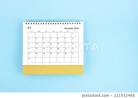 November 2025, Monthly desk calendar for 2025 year on blue background. 121552468