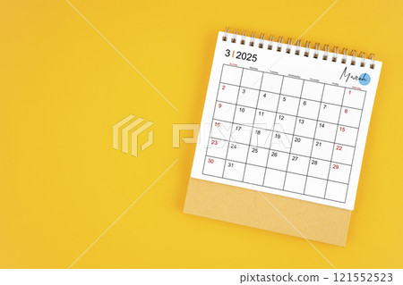 March 2025 desk calendar on yellow color background. 121552523