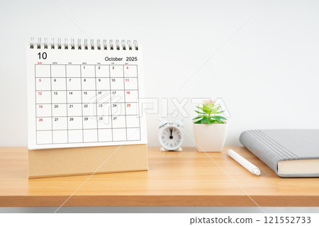 October 2025, Monthly desk calendar for 2025 year on wooden table. 121552733