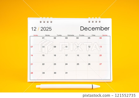 December 2025, Monthly desk calendar for 2025 year and pen on yellow background. 121552735