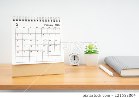 February 2025, Monthly desk calendar for 2025 year on wooden table. 121552804