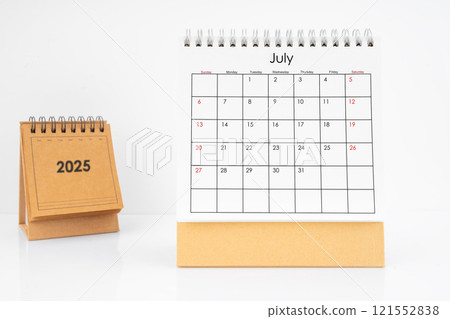 Monthly desk calendar July 2025 year on white table. 121552838