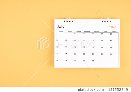 July 2025 desk calendar on yellow color background, position with copy space. 121552849