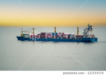 Dubai, UAE - 14 November 2024: Cargo ship loaded with various containers cruising in open sea. Ocean freight transport vessel moving goods globally. Maritime industry and international shipping 121555578