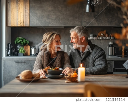 Couple enjoying a cozy dinner at home intimate setting lifestyle photography warm atmosphere heartfelt connection 121556114