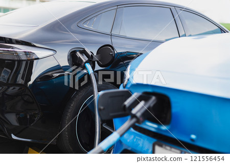 Electric car at charging station with the power cable supply plugged. 121556454