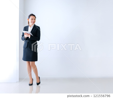Smiling businesswoman with a tablet Smiling businesswoman with a tablet 121556796