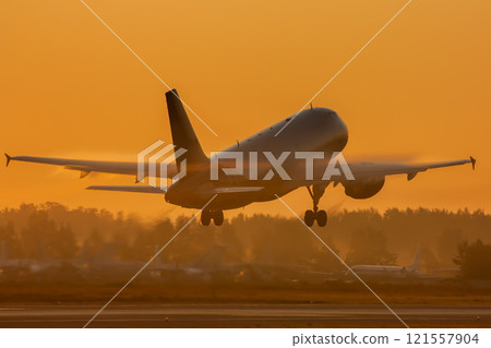 Passenger jet plane takes off in golden morning light Passenger jet plane takes off in golden morning light 121557904