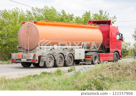 Fuel truck rides on a road in the countryside 121557908