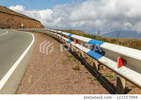 Scenic highway with guardrail winding through the mountains of Armenia on a clear day Scenic highway with guardrail winding through the mountains of Armenia on a clear day 121557994