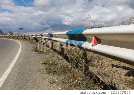 Scenic roadside view in Armenia with guardrails and distant mountain backdrop Scenic roadside view in Armenia with guardrails and distant mountain backdrop 121557995