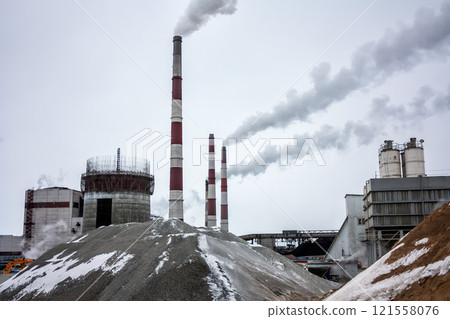 Fuming chimneys and industrial buildings of the condensing power plant Fuming chimneys and industrial buildings of the condensing power plant 121558076