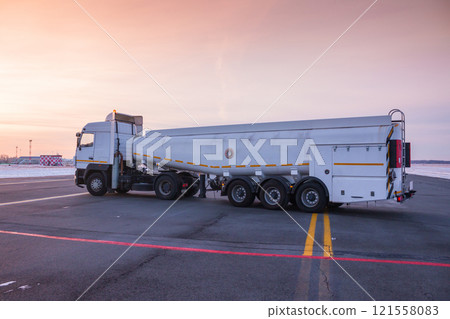 White tank truck aircraft refueler at the airport apron White tank truck aircraft refueler at the airport apron 121558083