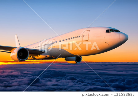 Close-up wide body passenger airplane is flying in the sunrise sky Close-up wide body passenger airplane is flying in the sunrise sky 121558683