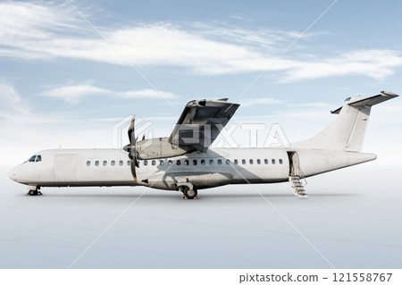 White passenger turboprop aircraft with an open staircase ladder isolated on bright background with sky 121558767