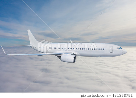 White passenger airplane fly in the air above the clouds 121558791